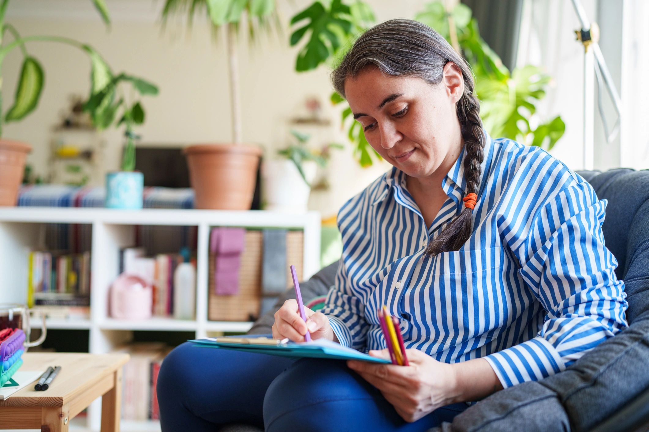 Woman journaling and studying at home